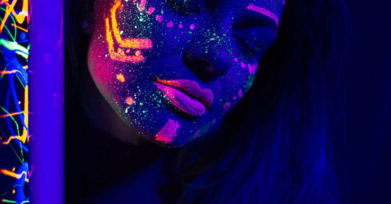 UV Resistance - Tranquil woman with neon paint on face