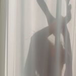 Translucent Materials - Shadow of anonymous female dancer performing sensual movements behind translucent white curtains in sunlight