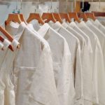 Composite Basics - Clothes in Neutral Colors Hanging on the Racks in a Clothing Store