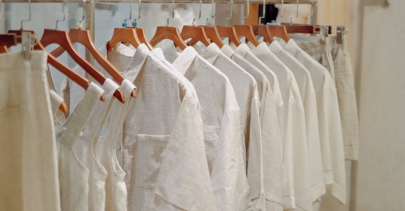 Composite Basics - Clothes in Neutral Colors Hanging on the Racks in a Clothing Store