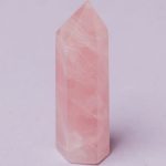 Material Quality - Closeup of pink quartz natural stone obelisk polished in jewelry workshop