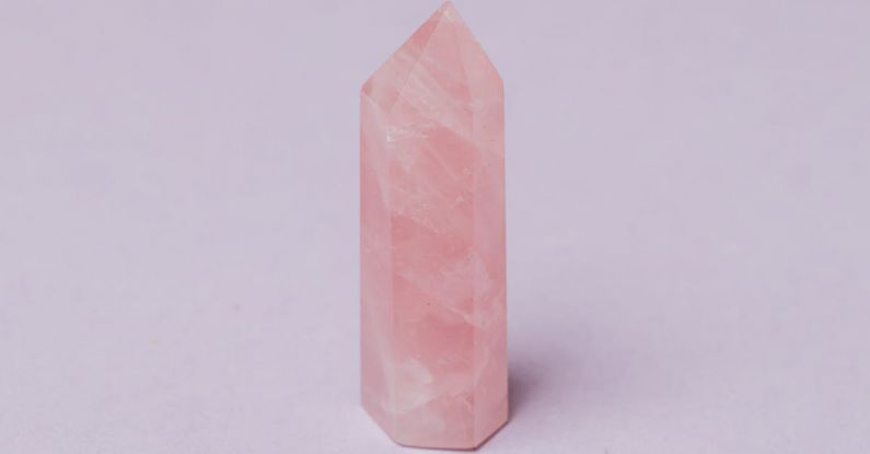 Material Quality - Closeup of pink quartz natural stone obelisk polished in jewelry workshop