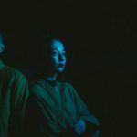 Custom Aesthetics - Photo Of Man And Woman With Blue Light Reflection On Black Background