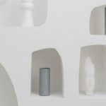 Parametric Design - A white wall with shelves and vases