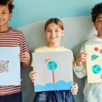 Challenging Projects - Young Students Holding their Art Projects