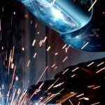 Advanced Manufacturing - Person in Welding Mask While Welding a Metal Bar