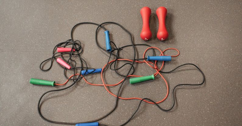 Sporting Goods - Jumping Ropes and Dumbbells on Gray Surface