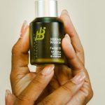 Sustainable Packaging - Person Holding a Facial Oil Bottle